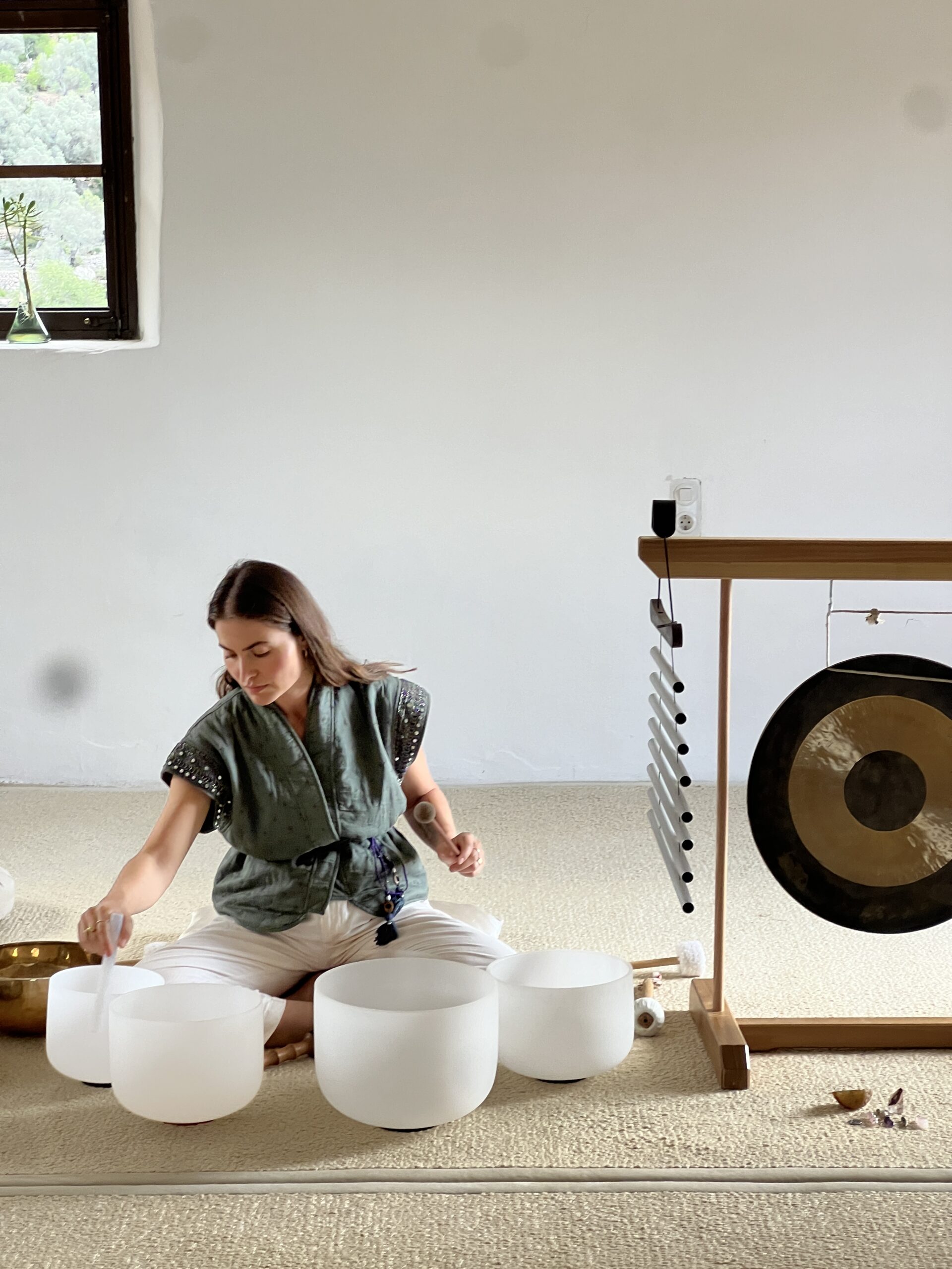 Sedef playing singing bowls in the quiet space at Son Rullan